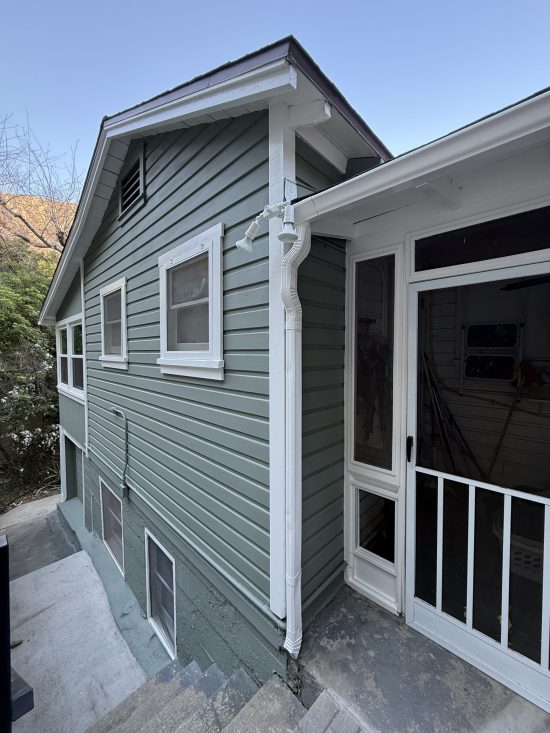 side of house with new light green paint and white trim