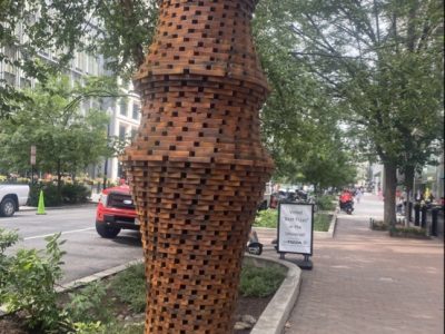 wooden art installation sculpture on city sidewalk