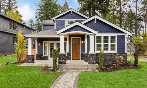 blue and white painted home with clean lawn