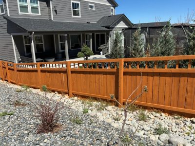 stained fence surrounding house