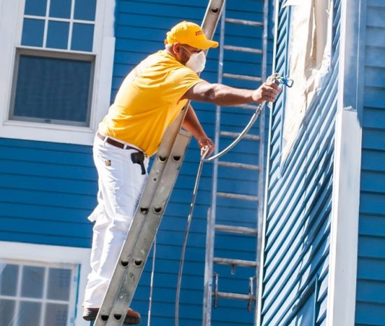 man painting house
