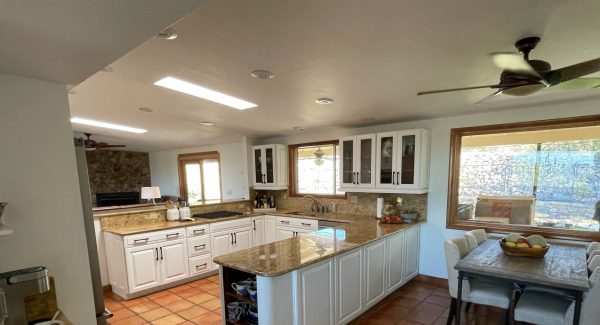 kitchen with white cabinets and dining room