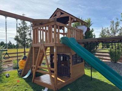 playscape structure with slide and swings