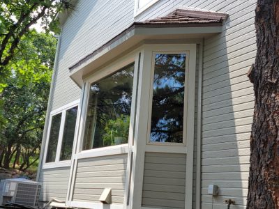 side window and painted siding of house