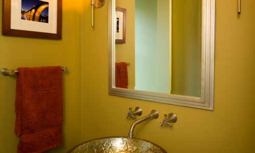 Gold powder room walls with gold sink