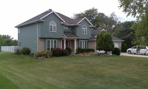Blue Green Siding with White Window Trim