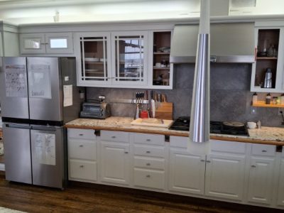 home kitchen with white painted cabinets and wood floors