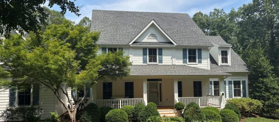 street view of house with white painted siding and blue shutters