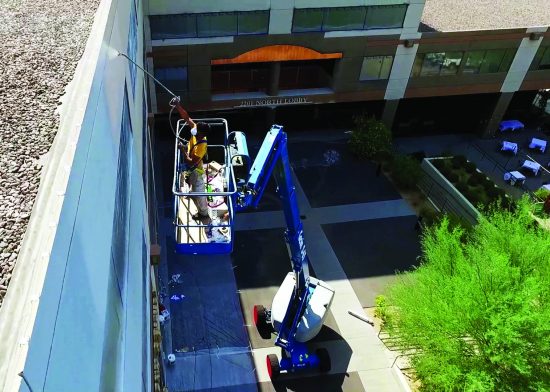 exterior parking garage painting with boom lift