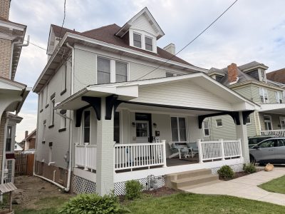 white painted brick home exterior with black accents.