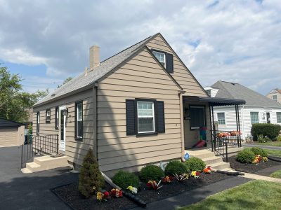 house with beige siding and black trim