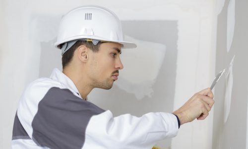 painter caulking and repairing walls