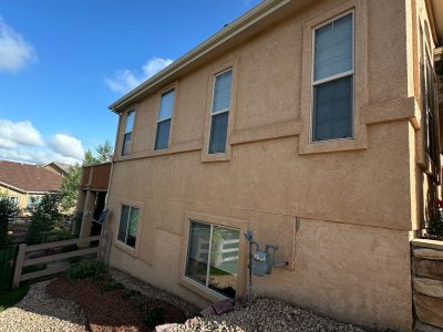 side of home with repainted stucco