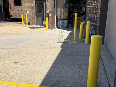 commercial bay area with repainted safety bollards