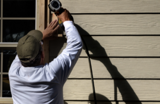 working on siding exterior