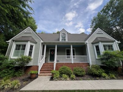 front side of house with repainted pale green siding