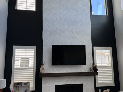 dark painted accent wall surrounding fireplace