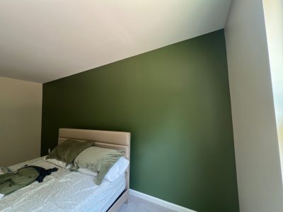 bedroom with green accent wall