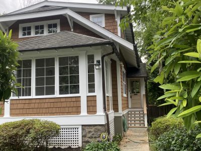 front of house with cedar shake siding and white trim
