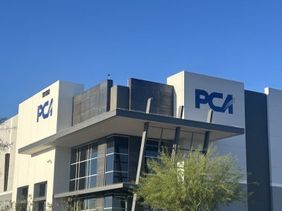 white and commercial building with blue painted logo
