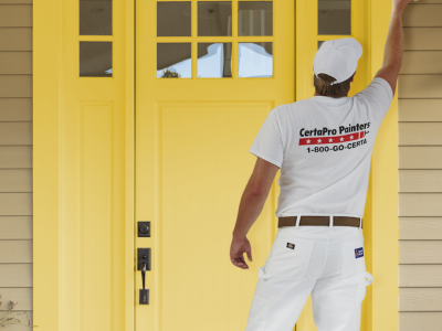 Painter painting front door yellow