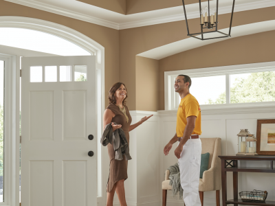 Man in Yellow Shirt with Smiling Woman in Foyer