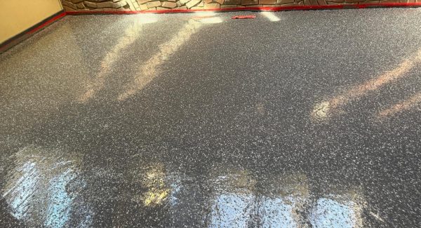 Wide view of finished grey flake epoxy flooring in an open production room at Echo Brewing in Loveland.