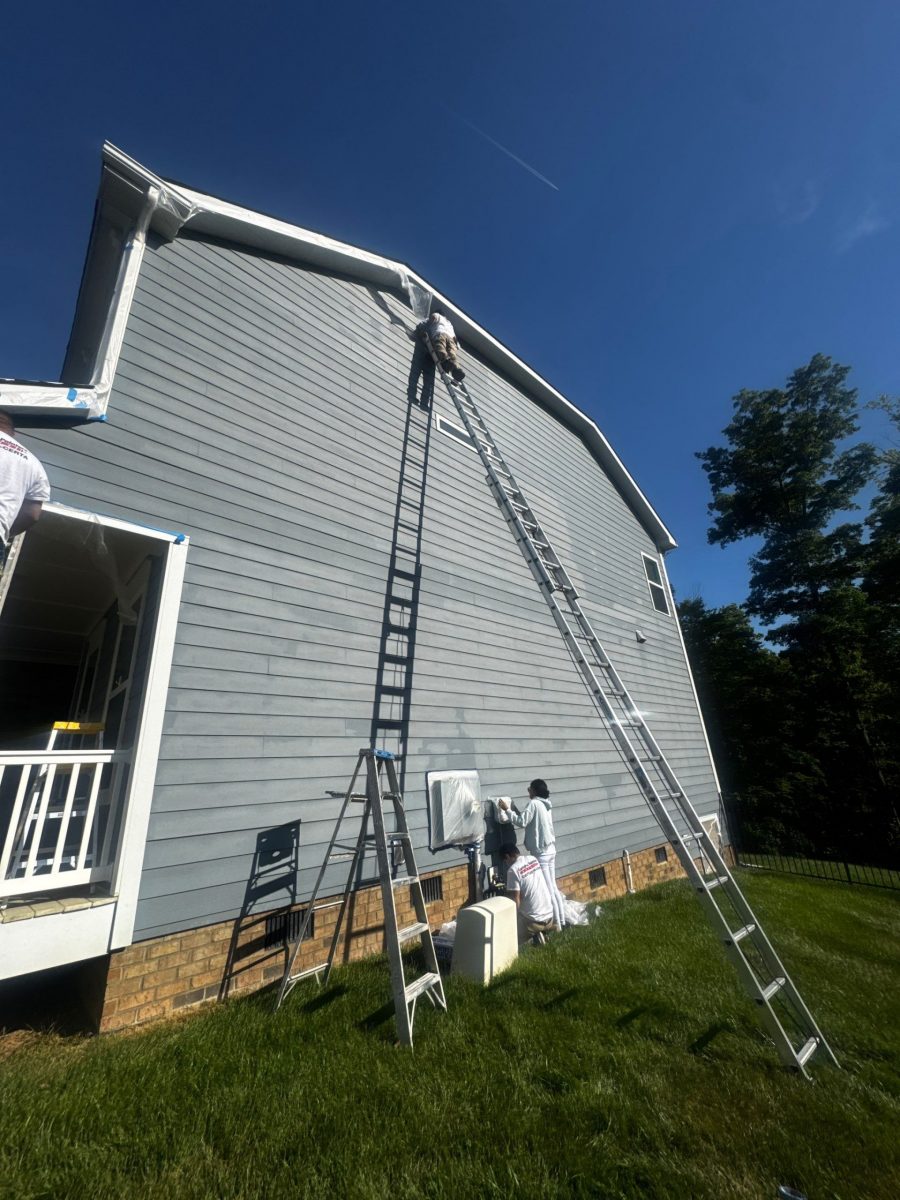 painters with ladder against house exterior during siding repaint Preview Image 3