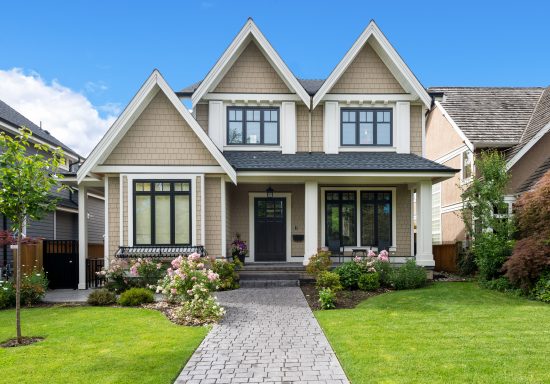 tan cedar siding home with black door