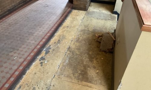 Old Red Tile Meeting Damaged Concrete